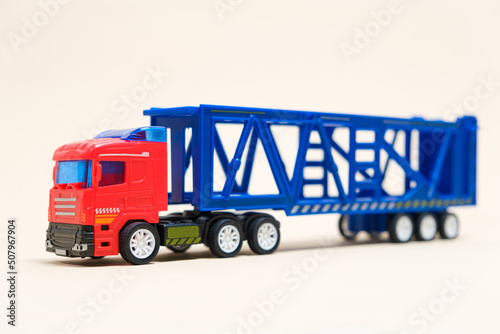 Toy car transporter with cars on a white background with place for text, copy space, for a toy store.
