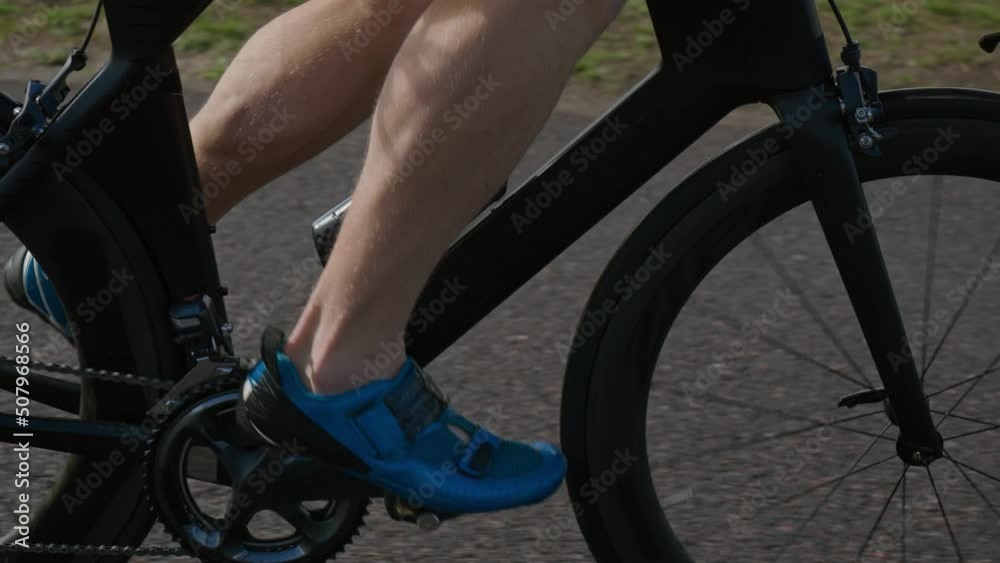 Self-improvement, an hardy triathlete rides a bike, pro cyclist rides on the road, athlete trains on a cutting bike. Self-improvement, an hardy triathlete rides a bike, pro cyclist rides on the road, athlete trains on a cutting bike.