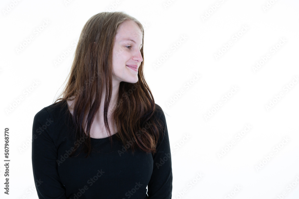 friendly smiling young woman with beautiful face profile side view portrait studio shot aside white copy space friendly smiling young woman with beautiful face profile side view portrait studio shot aside white copy space