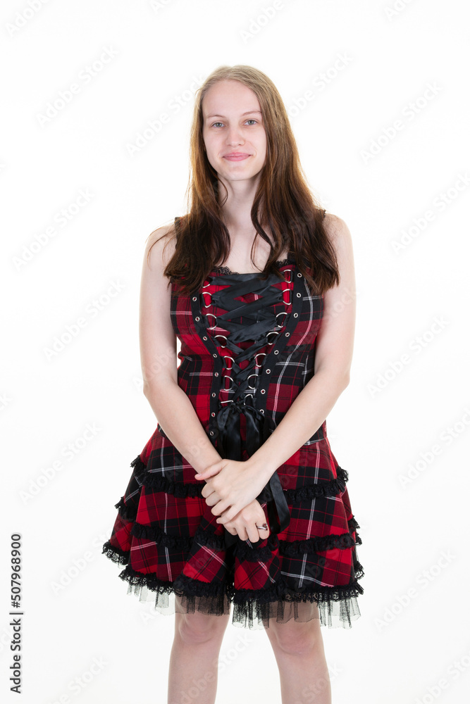 Happy smile beautiful woman in retro scottish checkered red dress posing in studio isolated on white background Happy smile beautiful woman in retro scottish checkered red dress posing in studio isolated on white background