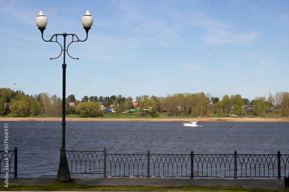 Volga River embankment in Rybinsk.A lantern and a yacht in the distance