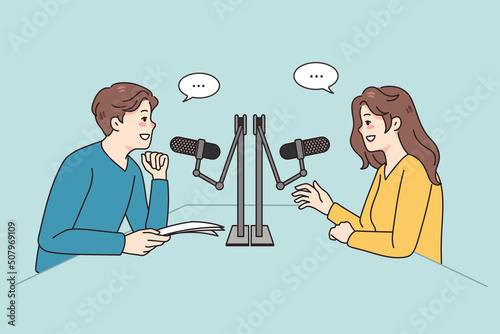 Smiling diverse people talk in studio in microphones record podcast together. Happy radio host interview guest at station. Entertainment industry. Vector illustration. 