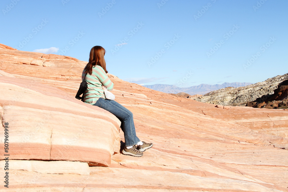 A hiker overlooks Valley of Fire State Park in Nevada A hiker overlooks Valley of Fire State Park in Nevada