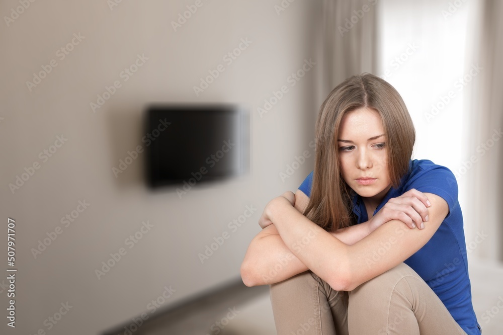 Serious teen pose alone in living room. Adolescence, difficult personality, bad temper, young generation Serious teen pose alone in living room. Adolescence, difficult personality, bad temper, young generation