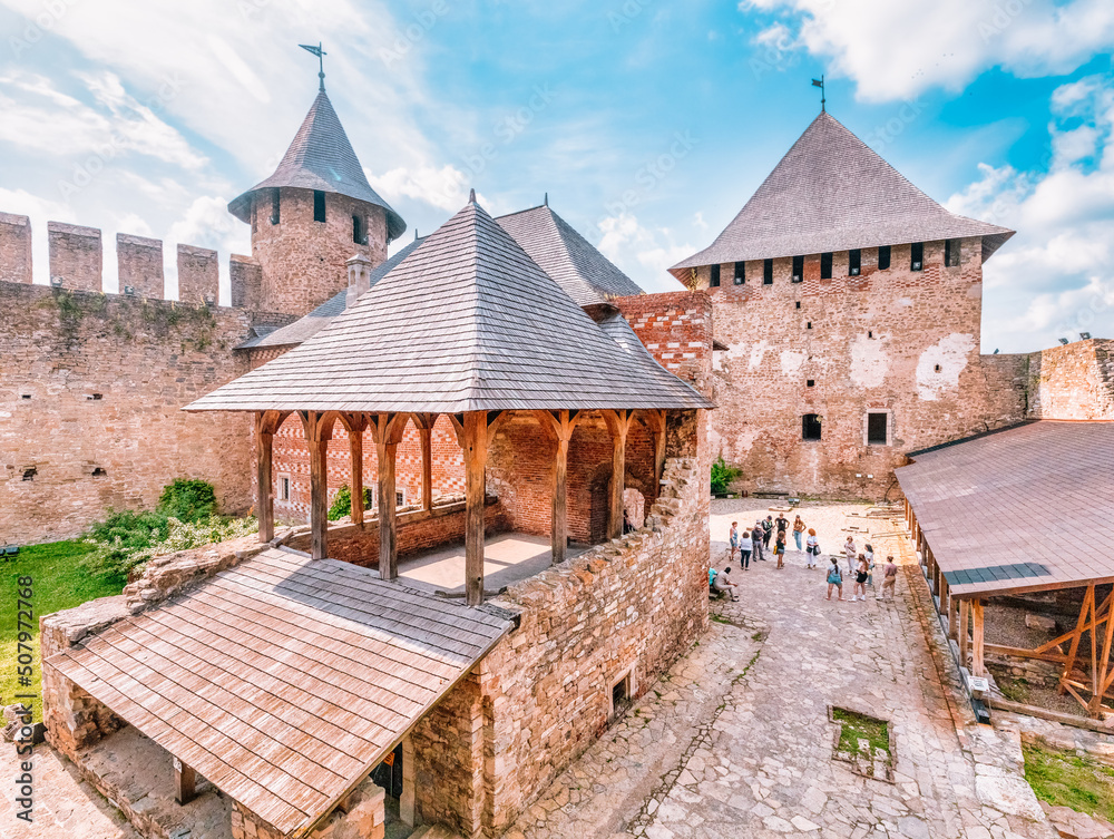 KHOTYN, UKRAINE - JULY 02, 2021, courtyard inside the Khotyn fortress. A group of tourists on an excursion. KHOTYN, UKRAINE - JULY 02, 2021, courtyard inside the Khotyn fortress. A group of tourists on an excursion.