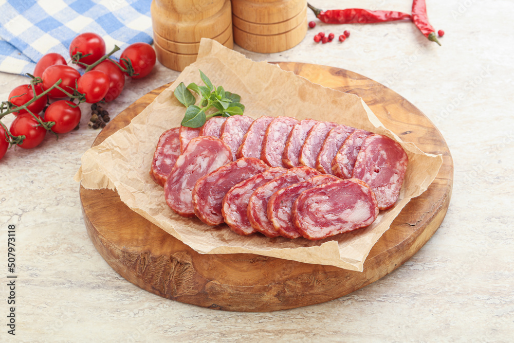 Sliced salami sausages over board Sliced salami sausages over board