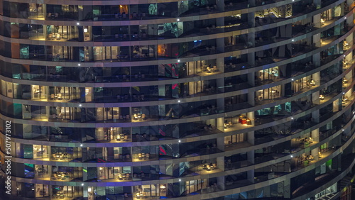 Outside view of windows in apartments of a high class building at night timelapse