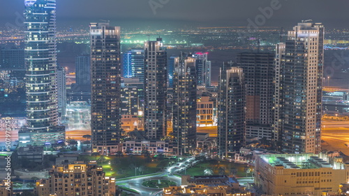 Aerial view of a big futuristic city night timelapse. Business bay and Downtown