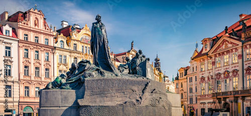 Morning view of Jan Hus monument - large stone and bronze memorial sculpture depicting a famous martyr, completed in 1915. Sunny spring cityscpae of Prague, the capital of the Czech Republic. photo