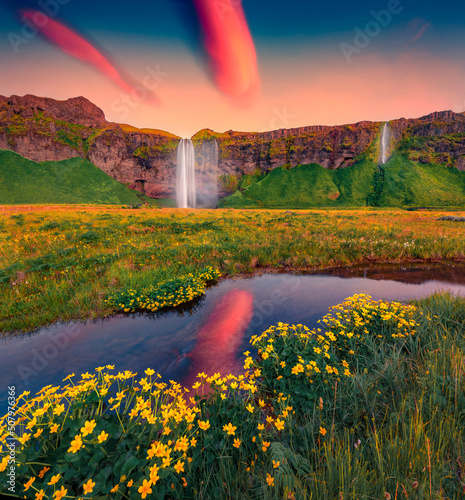 Calm summer sunrise on Seljalandsfoss - where tourists can walk behind the falling waters. Marvelous morning scene of Iceland, Europe. Beauty of nature concept background.