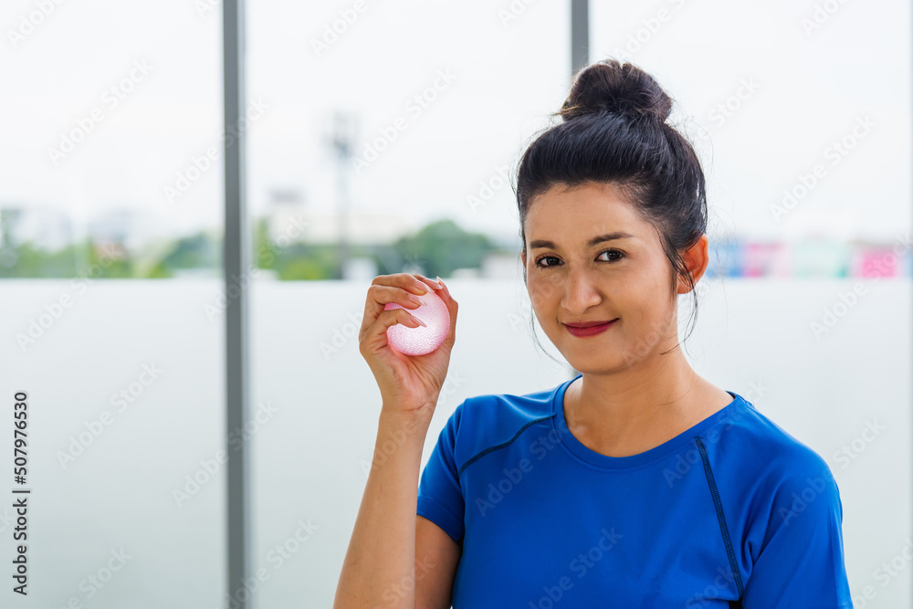 Asian lifestyle young woman in sportswear holding the rubber ball hand grip exercise indoor yoga studio, fit sport healthy workout exercise Asian lifestyle young woman in sportswear holding the rubber ball hand grip exercise indoor yoga studio, fit sport healthy workout exercise