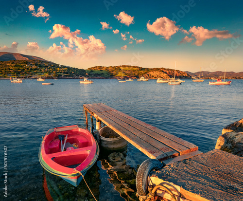 Fototapeta Naklejka Na Ścianę i Meble -  Small wooden pier on Nuevo Loca Beach. Captivating sunrise on Aegean sea. Stunning morning scene of outskirts of Anavyssos town, Greece, Europe. Traveling concept background.