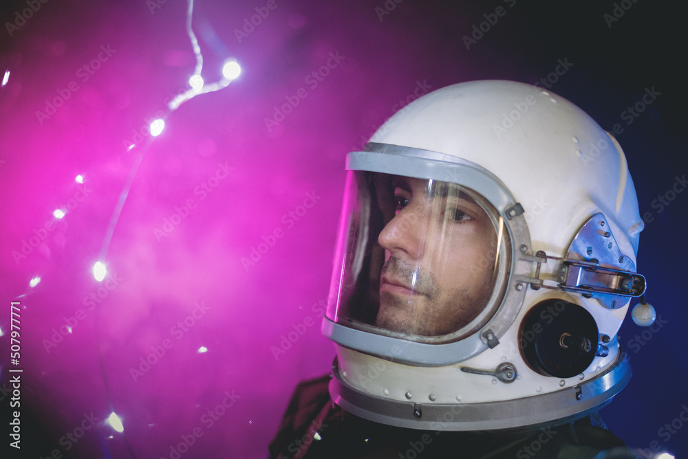 Spaceman in the in helmet and spacesuit on the blinking stars background concept.