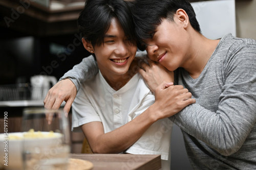 An asian young gay men couples showing some love affection  arms around each other