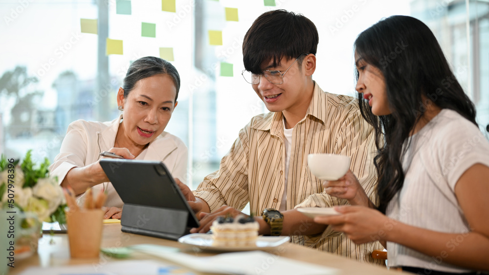 A group of business people working together in the office A group of business people working together in the office