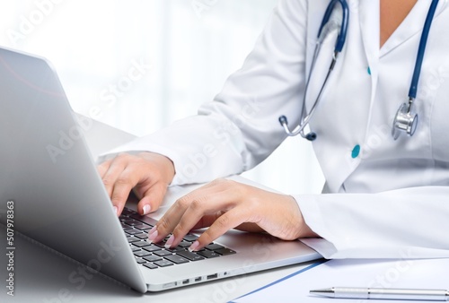 Serious medic professional  doctor  physician using laptop  giving online virtual consultation. Telemedicine  remote appointment