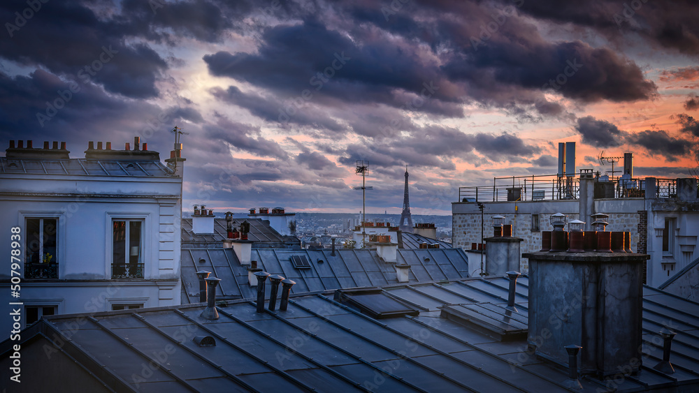 Colorful cloudy twilight above the rooftops of Paris, France viewed from the top of the Montmartre hill.