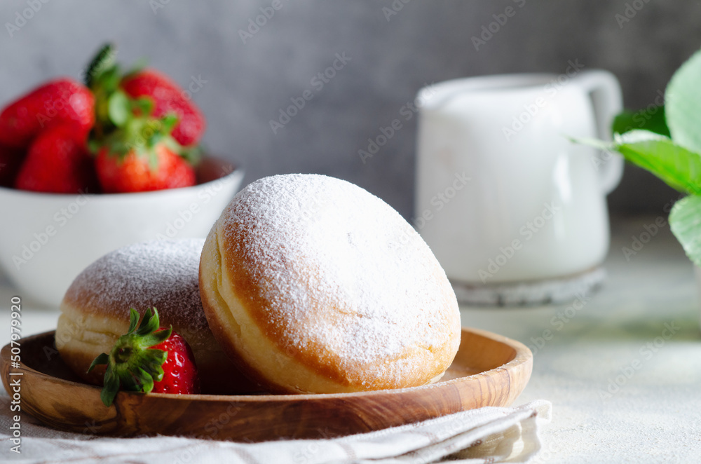Fresh doughnut for breakfast on wooden plate. Fresh doughnut for breakfast on wooden plate.