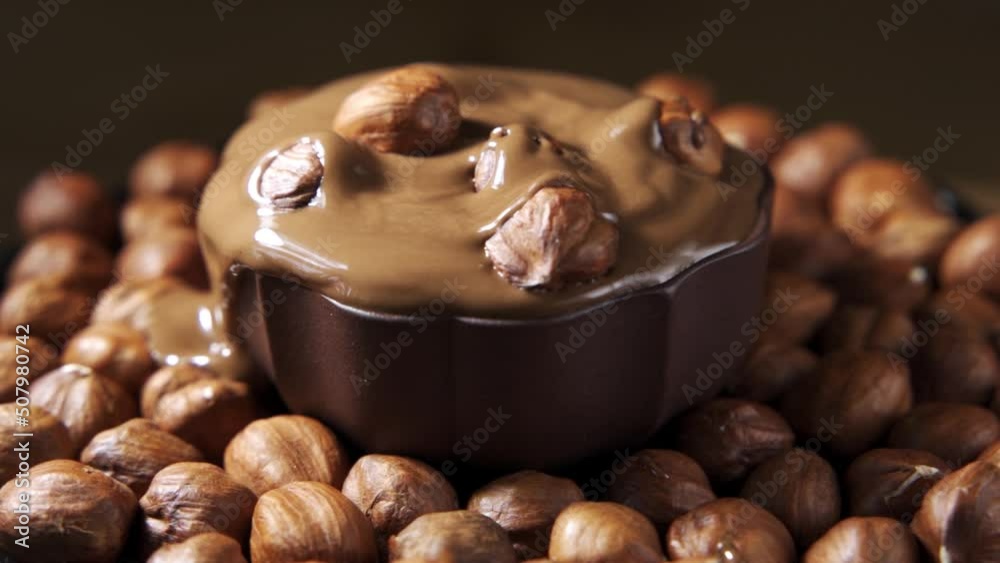 Pouring hot melted chocolate and almond nuts texture, close up, , 4k.