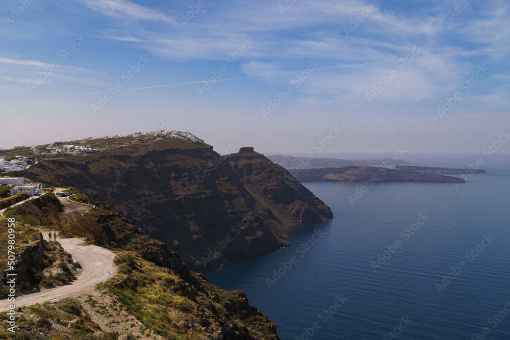 Coastal pathway leading to Imerovigli from North Santorini. Skaros rock can be seen in the distance. Landscape image.