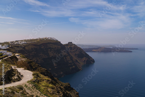 Coastal pathway leading to Imerovigli from North Santorini. Skaros rock can be seen in the distance. Landscape image.