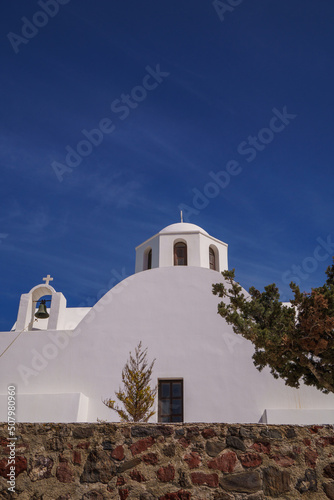 Beautiful monastery or church in Santorini at the top of a hill on the costal path near Imerovigli and Oia.