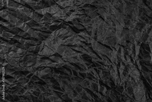 Black crumpled paper texture pattern. Rough grunge old blank.