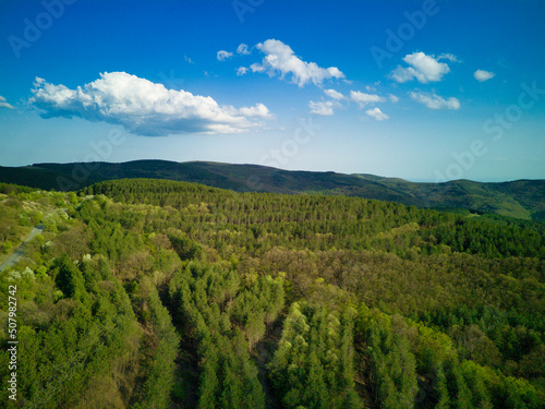 A view from a height of the meadows and slopes of the Balkan Mountains under daylight in Bulgaria