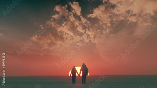 The two expeditors walking on the beautiful sunset sky background. slow motion photo