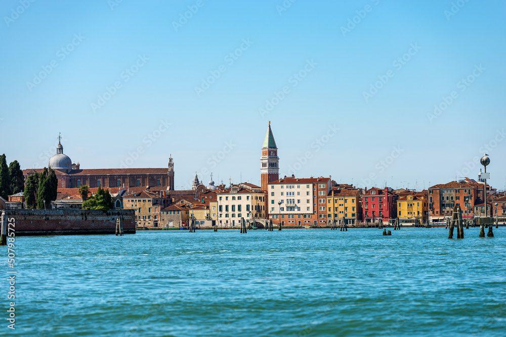 Venice cityscape with the Bell Tower of San Marco (Campanile), and the Basilica and Cathedral (St. Mark the evangelist), seen from the lagoon, UNESCO world heritage site, Veneto, Italy, Europe.