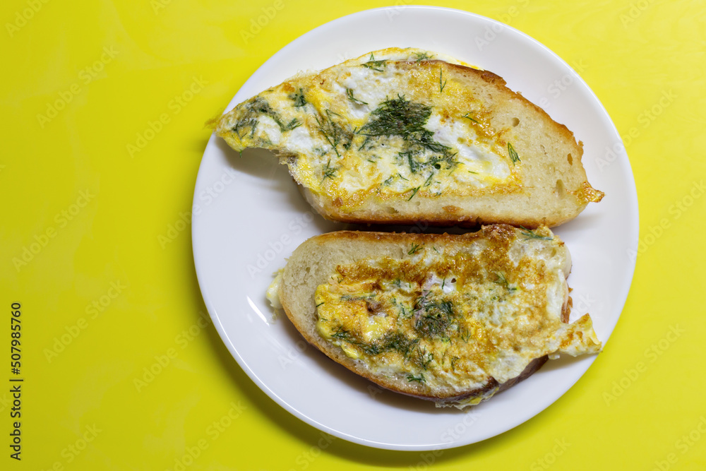 sandwiches with egg and herbs on a white plate