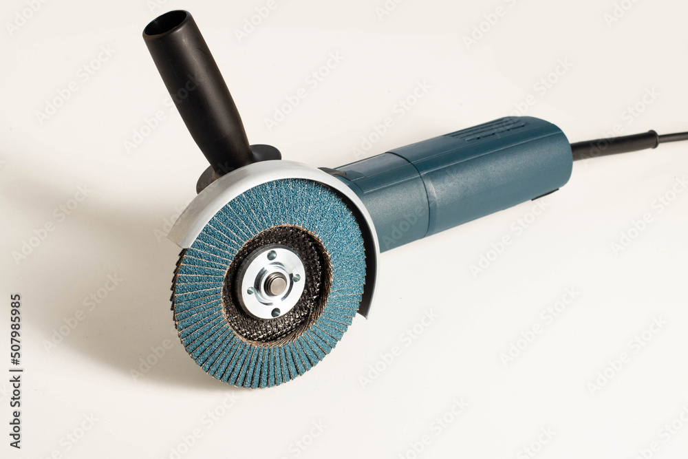 Modern professional angle grinder with a flap wheel on a white