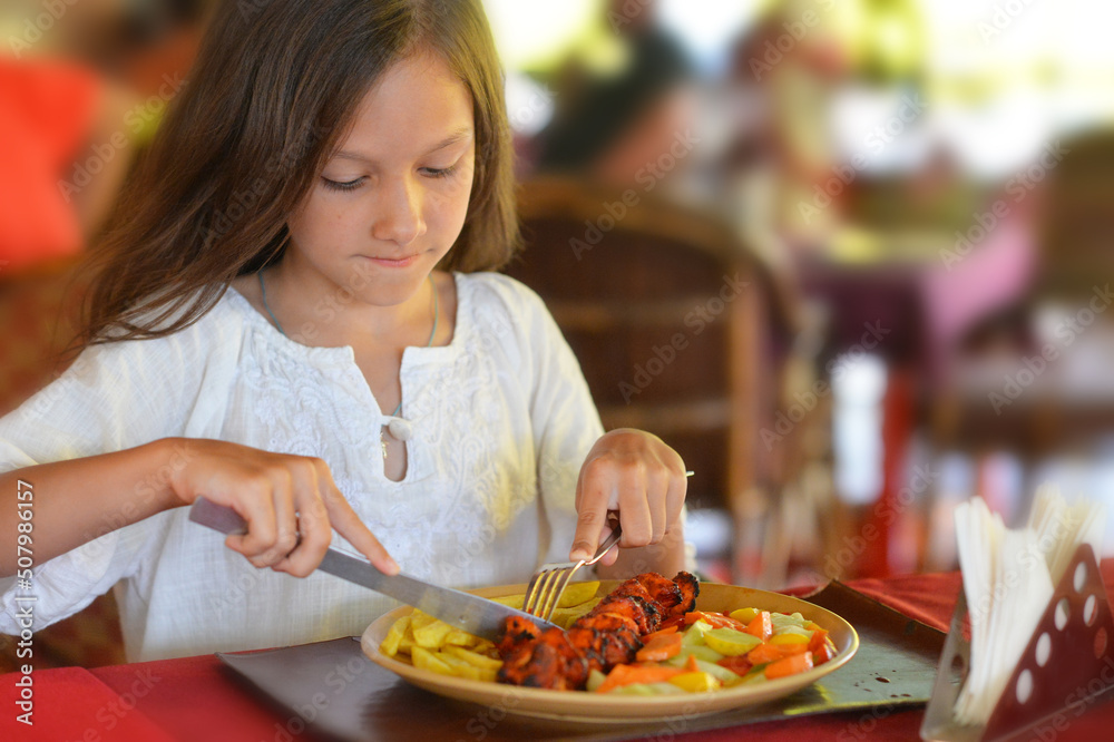 Portrait of little girl eating in cafe Portrait of little girl eating in cafe