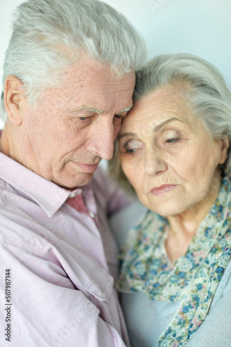 Close-up portrait of sad senior couple posing