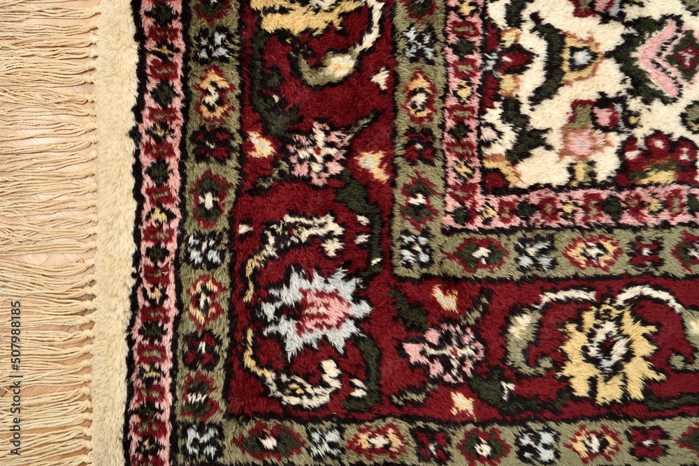 Detail of a very old Persian carpet after cleaning, washing and repairing. Close-up. Top view.