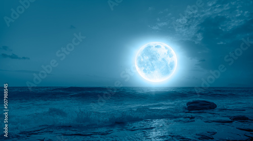 Night sky with full moon in the clouds  Elements of this image furnished by NASA