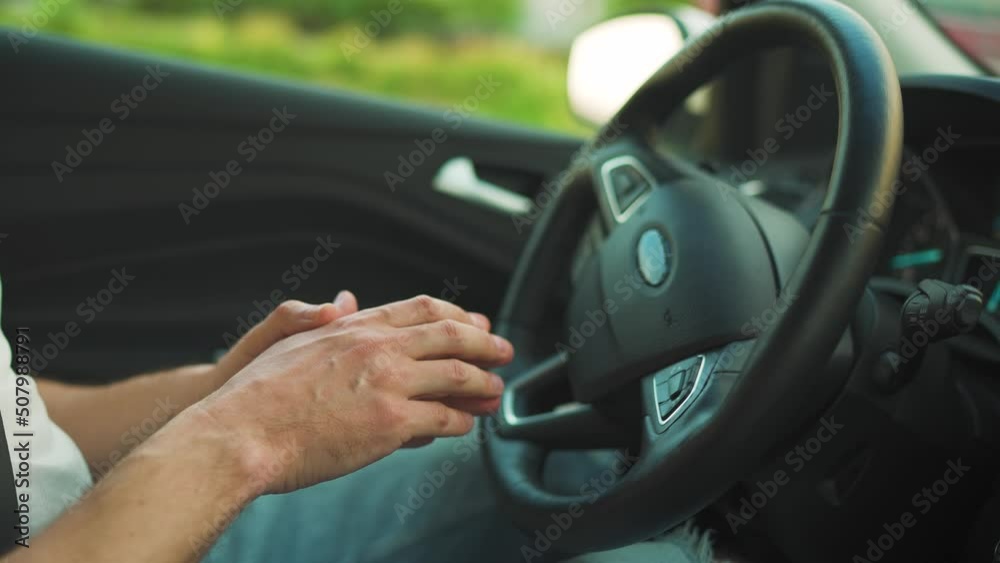 Man driving in innovative automated car using self-parking autopilot for parking on parking lot Man driving in innovative automated car using self-parking autopilot for parking on parking lot