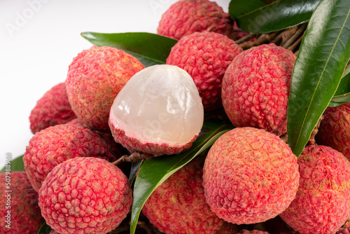 Close up shot Fresh Lychee with leaves white background, Sweet lychees fruits with leaves on White