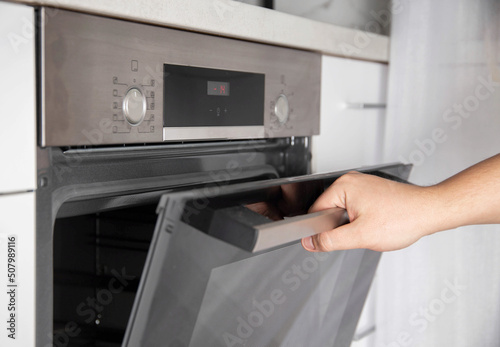 Black modern electric oven in white kitchen with thermo grill and convection function. 3d hot air and vario-grill, large