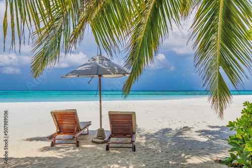 Tropical beach nature as summer landscape with lounge chairs and palm trees and calm sea for beach banner. Luxury travel landscape  beautiful destination for vacation or holiday. Couple beach scenic