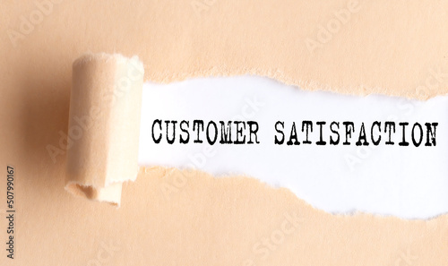 The text CUSTOMER SATISFACTION appears on torn paper on white background.