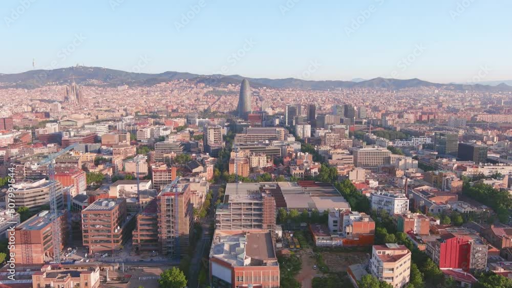 Barcelona, Spain: Aerial view of capital city of Catalonia, modern part of city with high-rise buildings, sunny day with blue sky - landscape panorama of Europe from above Barcelona, Spain: Aerial view of capital city of Catalonia, modern part of city with high-rise buildings, sunny day with blue sky - landscape panorama of Europe from above