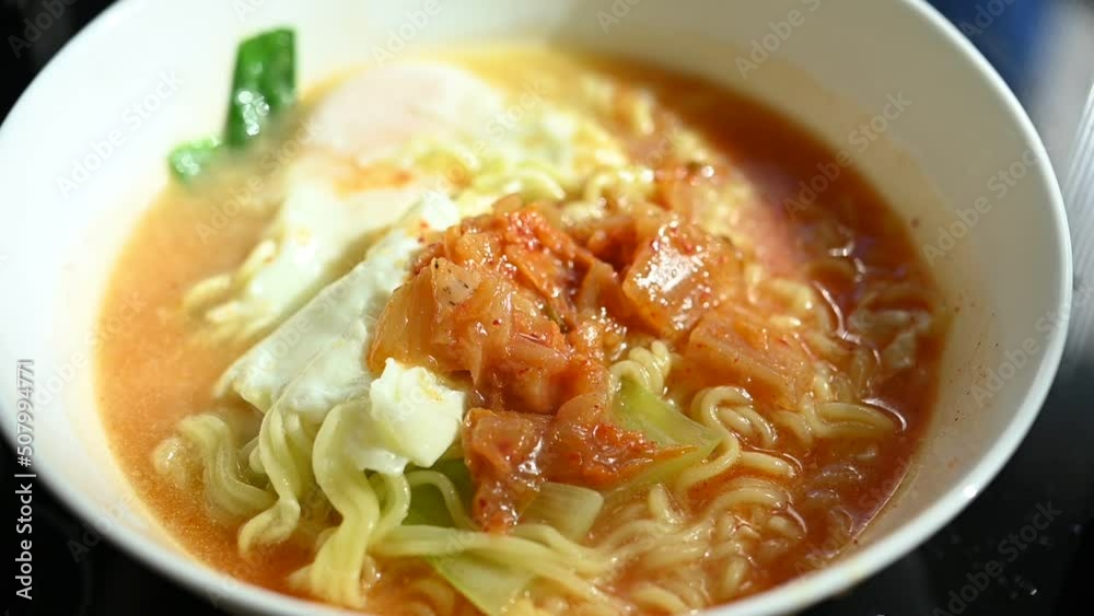 slow motion scene, spicy instant noodles easy food cooking with egg and kimchi slow motion scene, spicy instant noodles easy food cooking with egg and kimchi