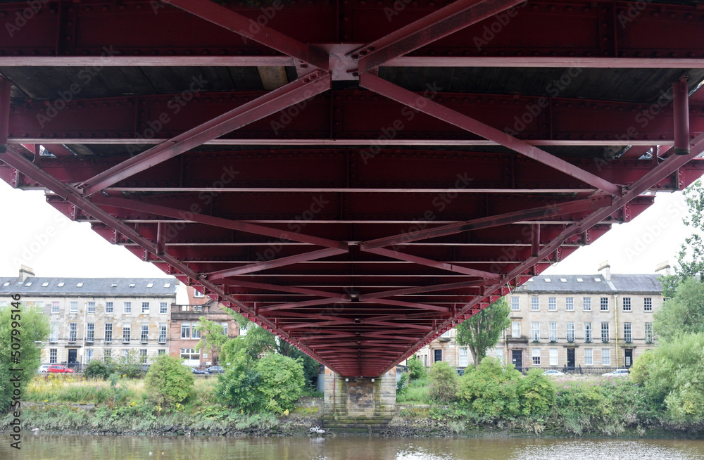 Underside of Steel Suspension Bridge Spanning River Underside of Steel Suspension Bridge Spanning River