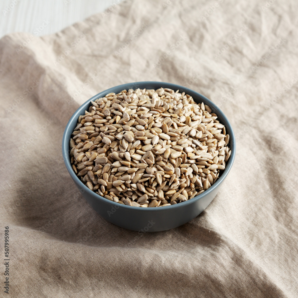 Raw Organic Sunflower Seed Kernels in a Blue Bowl, low angle view. Raw Organic Sunflower Seed Kernels in a Blue Bowl, low angle view.