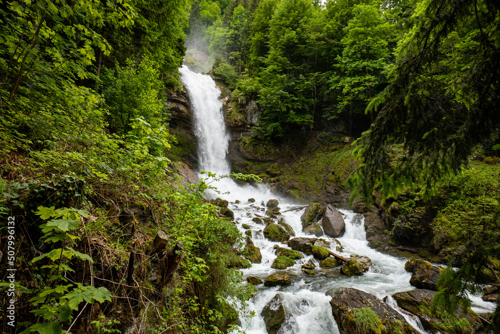 Beautifull large waterfall in the Swiss Alps. Sunny summer day, green nature, no people Beautifull large waterfall in the Swiss Alps. Sunny summer day, green nature, no people
