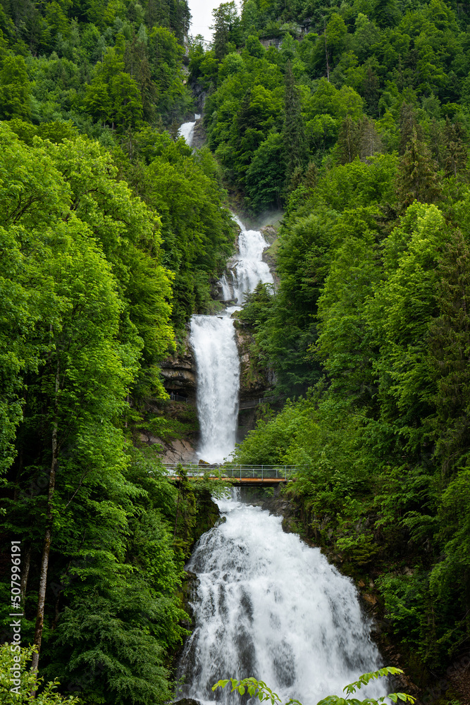 Giessbach waterfall in the Swiss Alps, Canton of Bern. Sunny summer day, green nature, no people