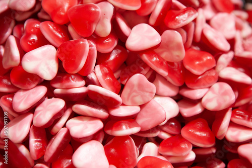Candy sweets jelly. Close up view of delicious sweet candies in form of hearts. Fruit jelly in shop window. Sweets for Easter, Halloween. Unhealthy or organic food. Selective focus. Top view 