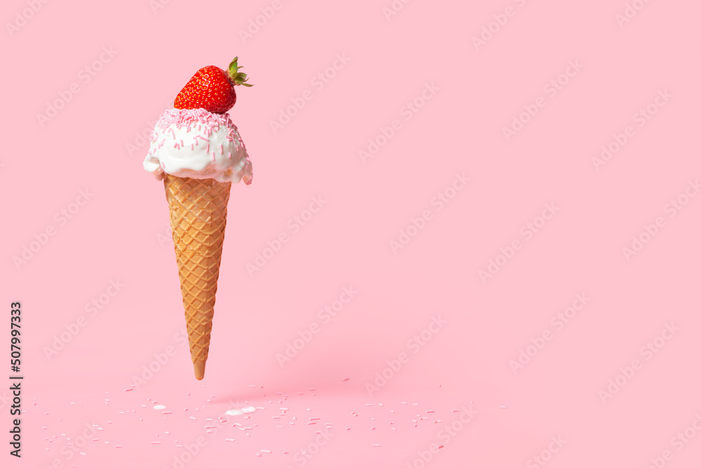 summer funny creative concept of flying wafer cone with ice cream, strewed sprinkles and decorated strawberry on pink background summer funny creative concept of flying wafer cone with ice cream, strewed sprinkles and decorated strawberry on pink background