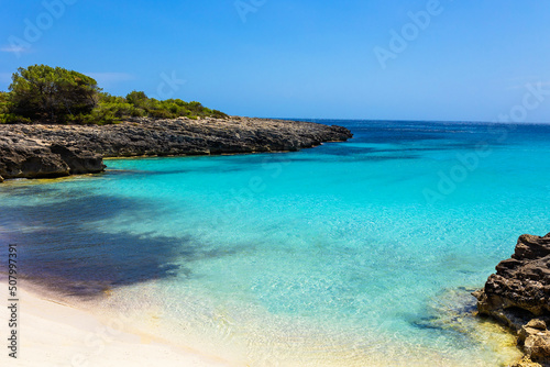 Cala Es Talaier in Menorca, Balearic Island, Spain - Beautiful turquoise sea water beach in sunny day